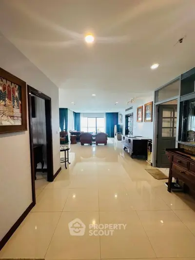 Spacious living room with elegant decor and large windows offering natural light.