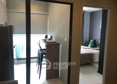 Modern apartment interior with cozy bedroom and dining area, featuring sleek design and natural light.