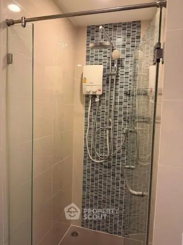 Modern bathroom with glass shower enclosure and stylish tile design