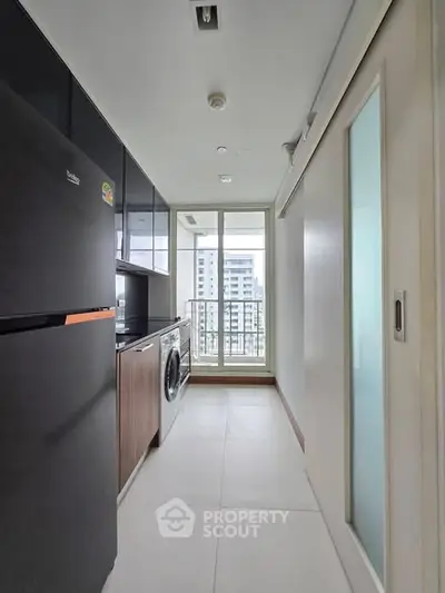 Modern kitchen with sleek appliances and city view from window