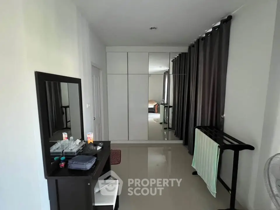 Spacious bedroom with sleek wardrobe and modern decor