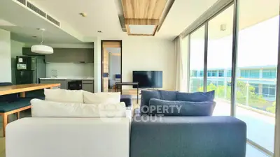 Modern living room with open kitchen and large balcony in luxury apartment