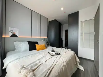 Modern bedroom with sleek design and cozy ambiance, featuring stylish decor and ample natural light.