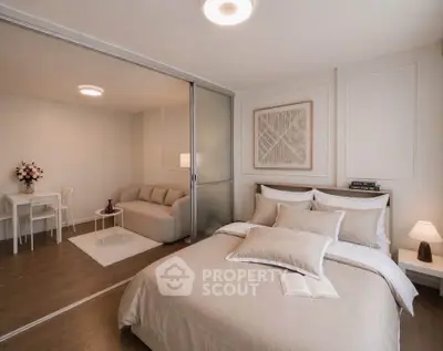 Modern bedroom with sliding glass doors and cozy living area in elegant apartment.