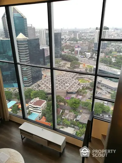 Stunning high-rise apartment view overlooking cityscape with modern architecture and lush greenery.