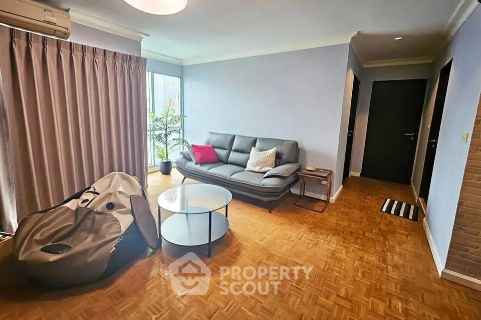 Spacious living room with modern decor and parquet flooring