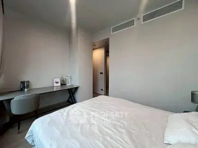 Modern bedroom with stylish desk and comfortable bedding