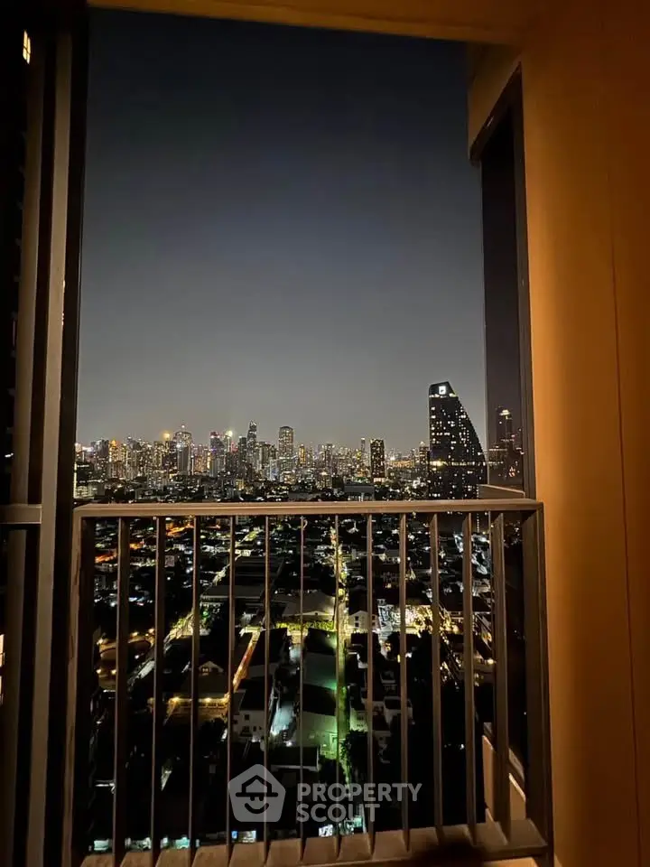 Stunning city skyline view from a high-rise balcony at night, perfect for urban living enthusiasts.