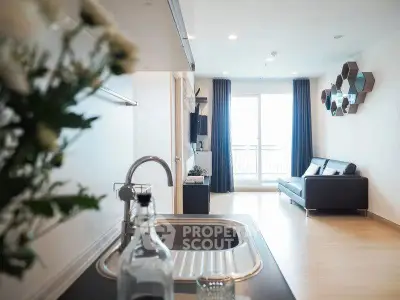 Modern open-plan living room with sleek kitchen and balcony view