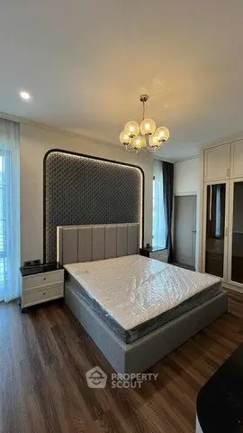 Luxurious bedroom with elegant chandelier and modern decor