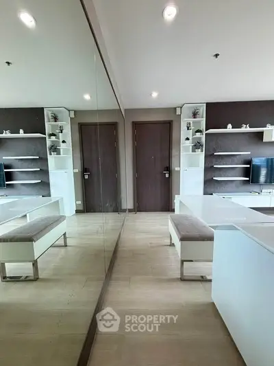 Modern living room with mirrored wall and sleek furniture design