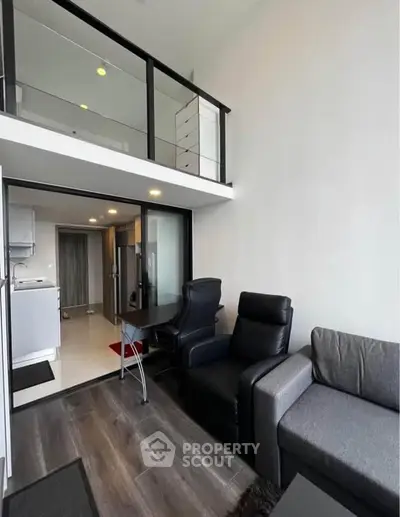 Modern loft-style living room with sleek furniture and mezzanine level, perfect for urban living.