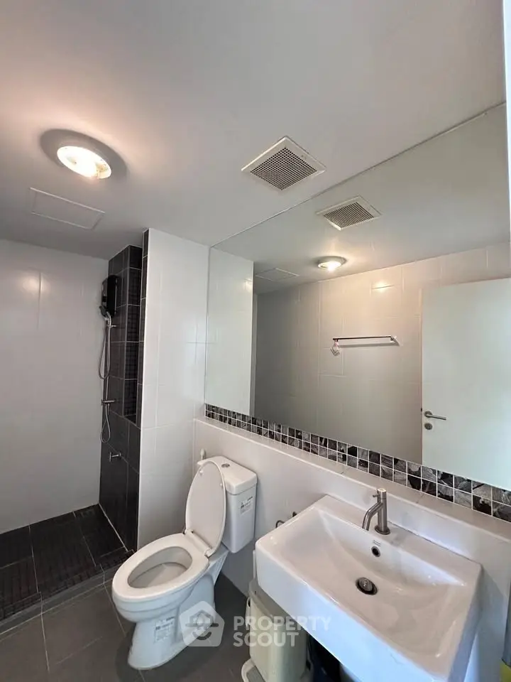Modern bathroom with sleek fixtures and spacious shower area