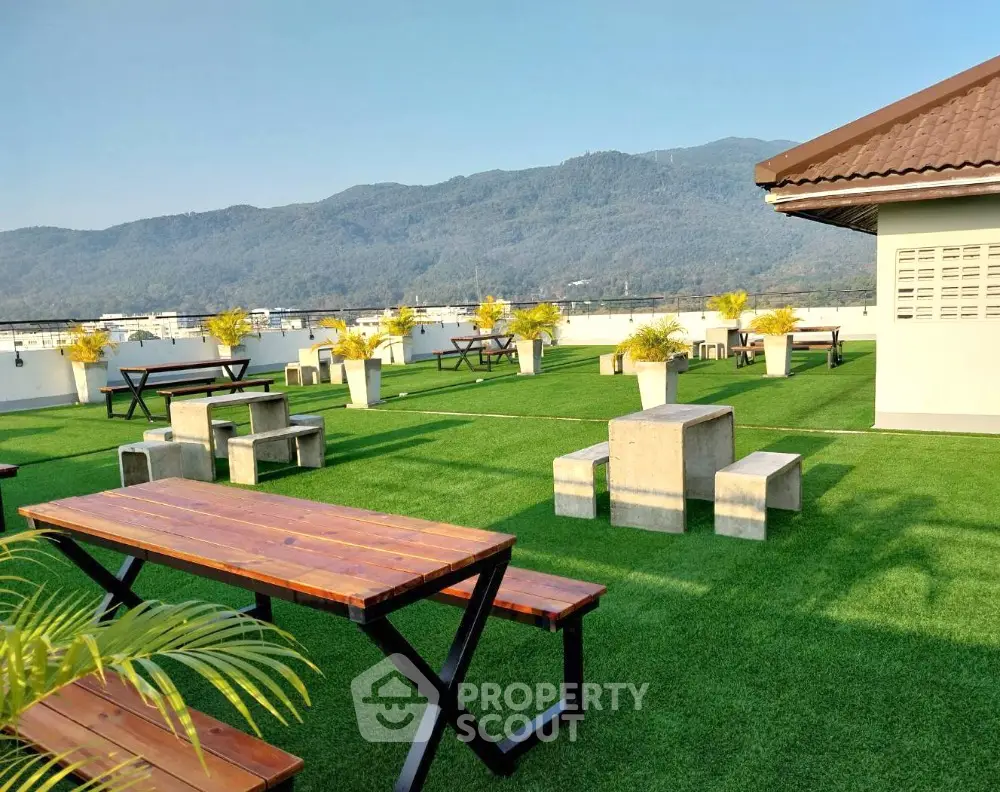Stunning rooftop with lush greenery and mountain views, perfect for relaxation and gatherings.