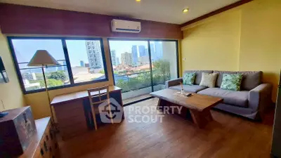 Spacious living room with city view, wooden flooring, and modern furniture in a high-rise apartment.