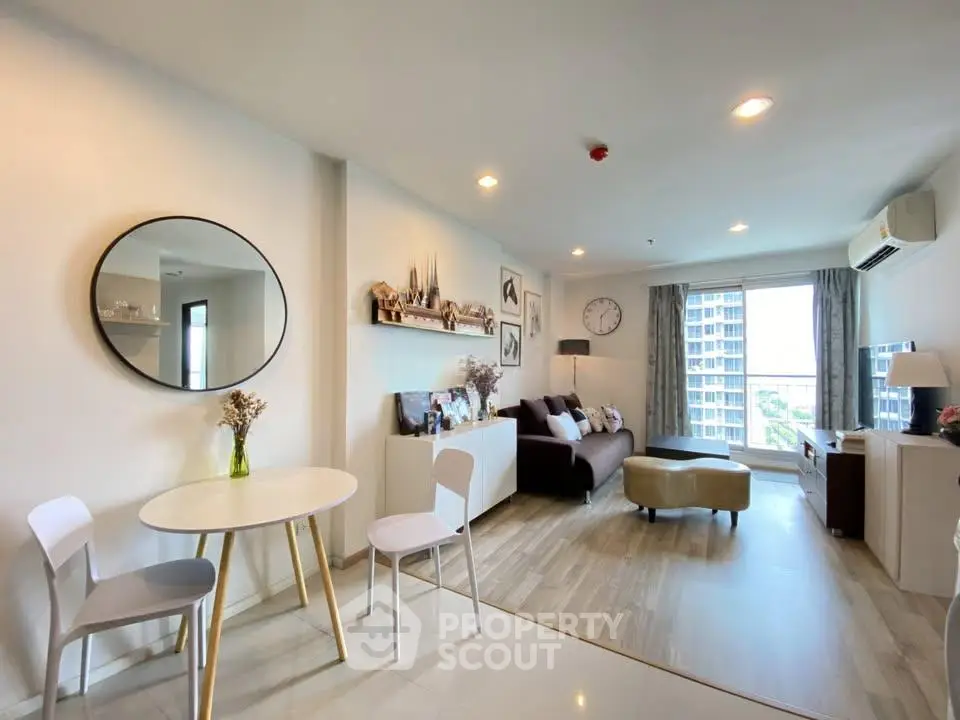 Modern living room with stylish decor and large window view in a contemporary apartment.