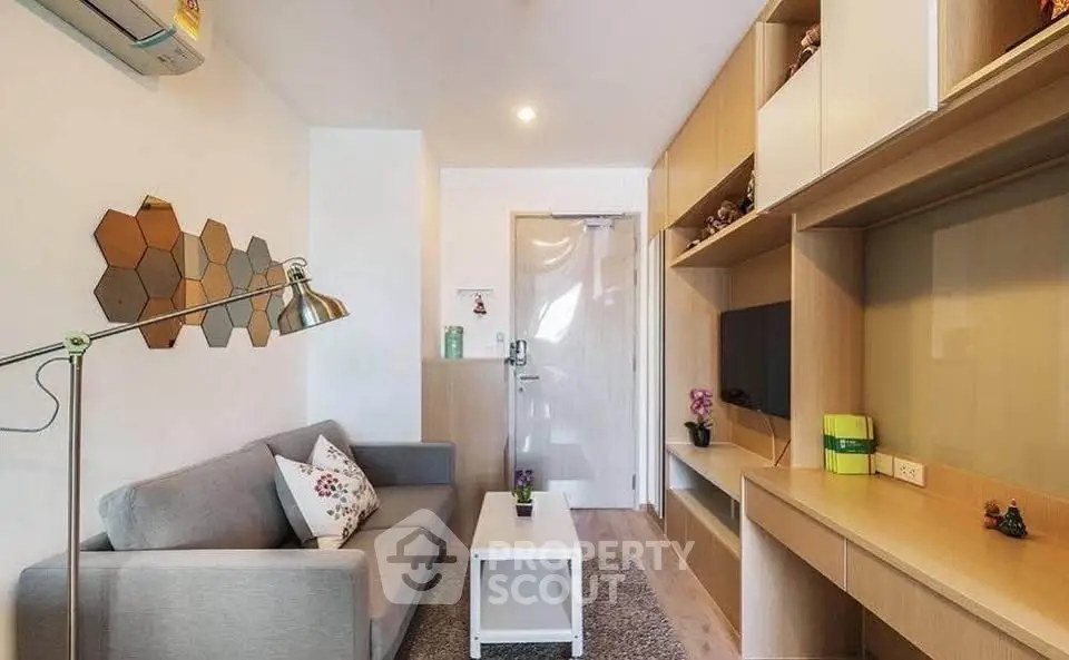 Modern living room with stylish decor and built-in storage in a cozy apartment.