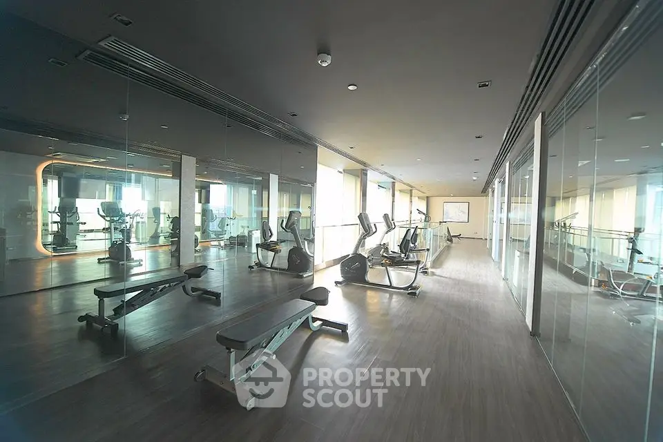 Spacious modern gym with state-of-the-art equipment and mirrored walls.