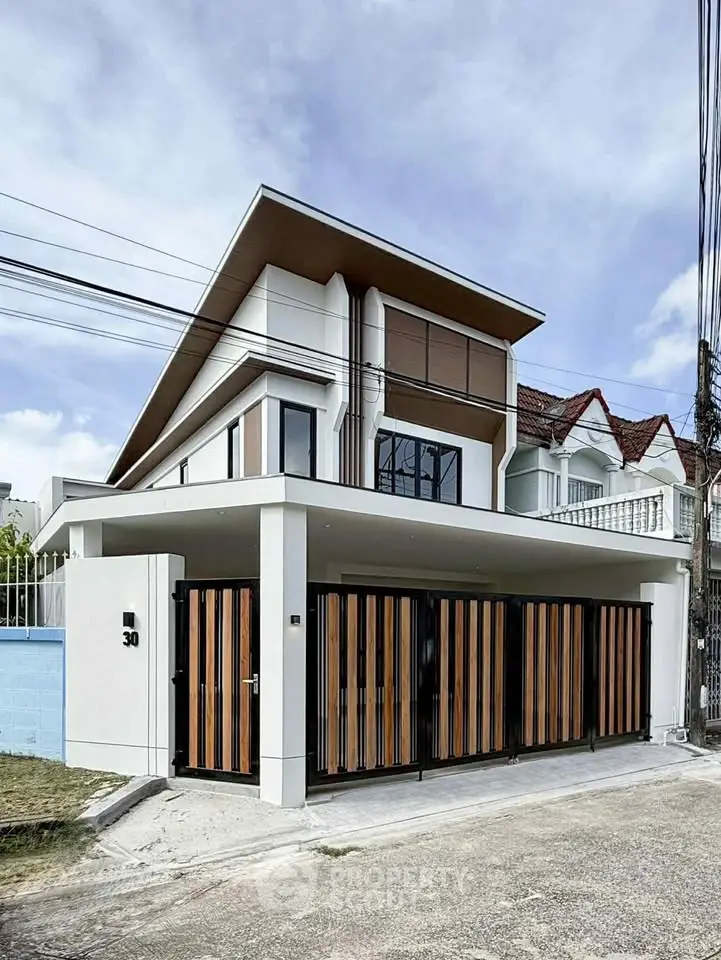 Modern two-story house with sleek design and gated entrance