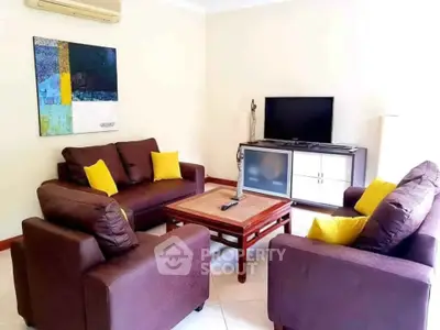 Cozy living room with modern furniture and vibrant decor accents.