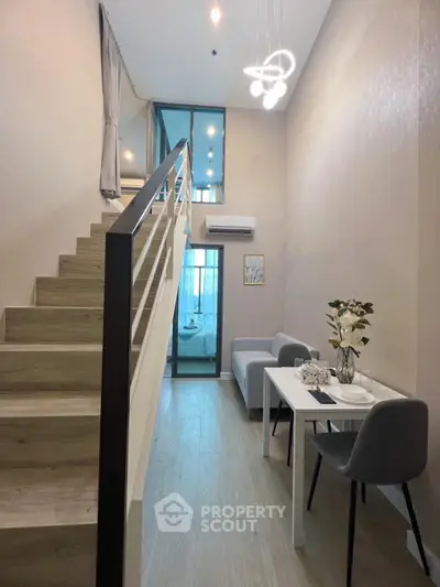 Modern duplex apartment with stylish staircase and cozy dining area