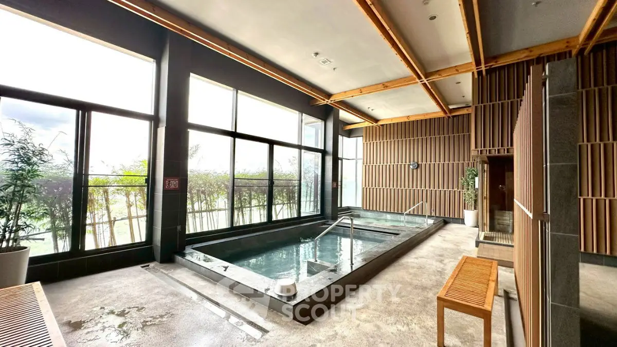 Luxurious indoor pool area with large windows and modern design.