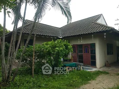 Charming rustic house with lush greenery and traditional roof design, perfect for nature lovers seeking tranquility.