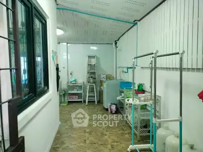 Spacious utility room with storage shelves and appliances, ideal for organizing household essentials.