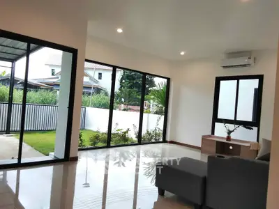 Spacious living room with large windows and garden view in modern home