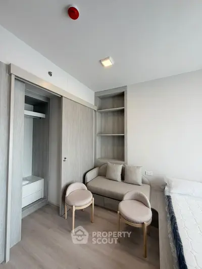 Modern bedroom with built-in closet and cozy seating area