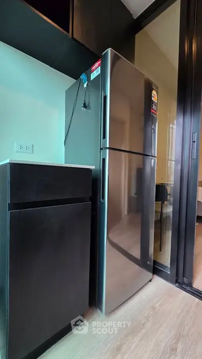 Modern kitchen with sleek stainless steel refrigerator and stylish cabinetry.