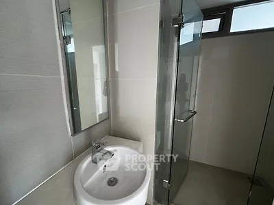 Modern bathroom with sleek glass shower and stylish sink in contemporary design.