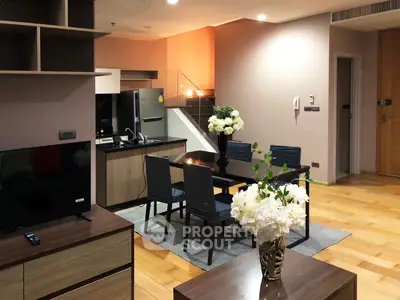 Modern open-plan living and dining area with stylish decor and hardwood floors