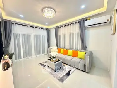 Elegant living room with modern decor, featuring a stylish sofa and ambient lighting.