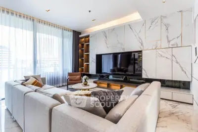 Luxurious modern living room with elegant marble accents and large sectional sofa, perfect for relaxation.