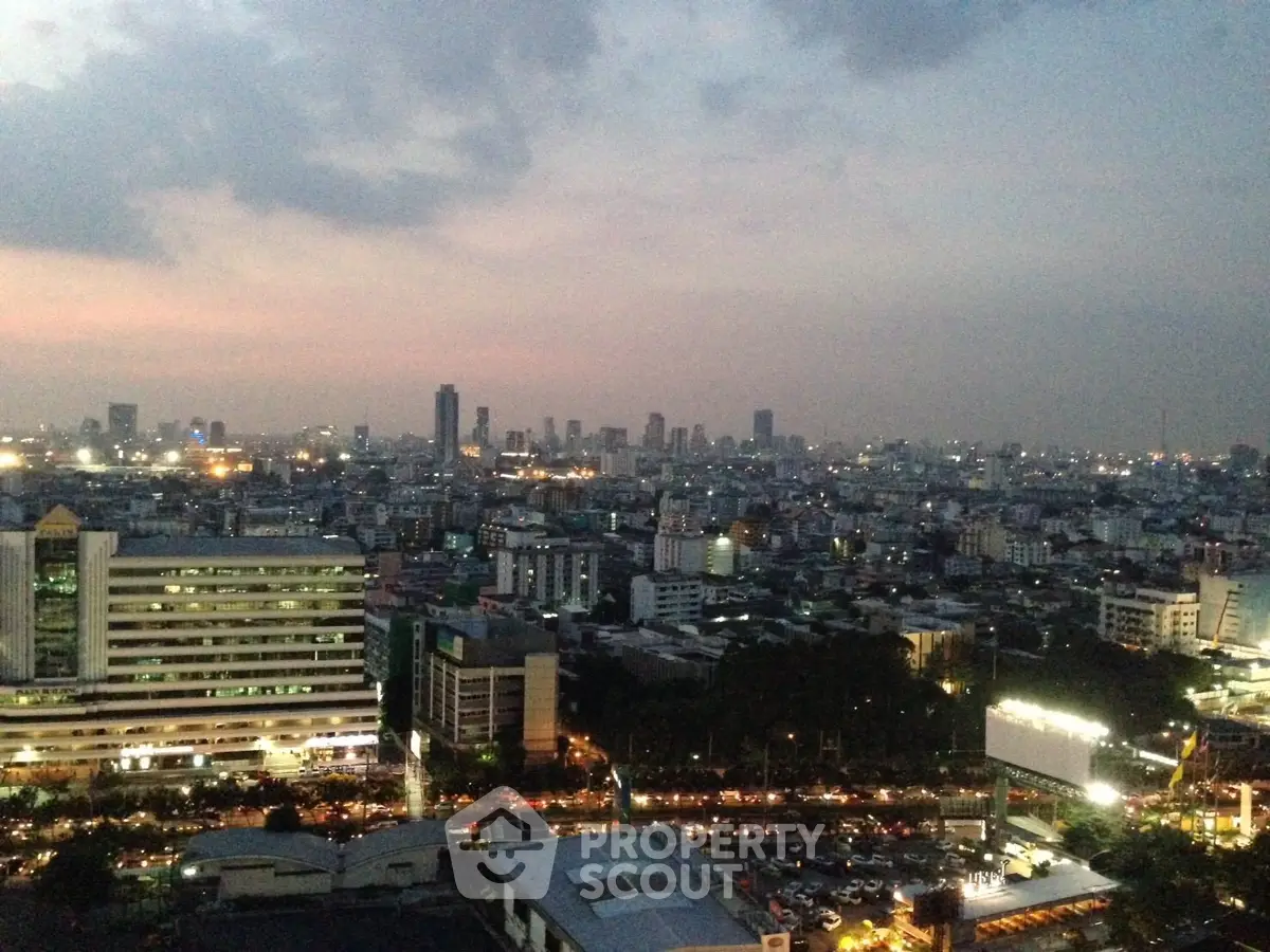 Stunning cityscape view from high-rise building at dusk, showcasing urban skyline and vibrant city lights.