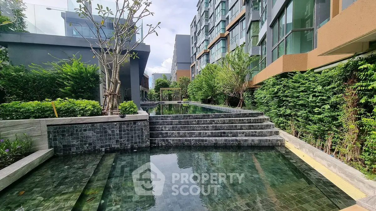 Luxurious residential pool area with modern architecture and lush greenery