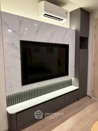 Modern living room with sleek TV unit and air conditioning