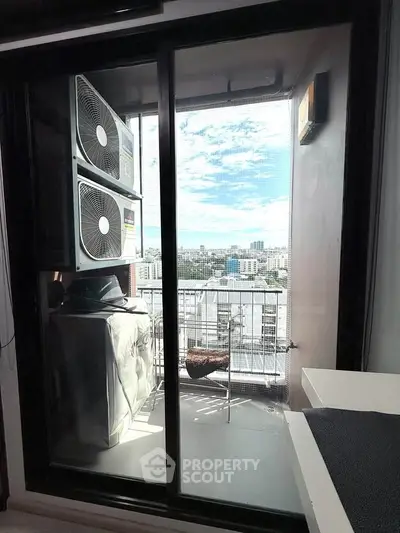 Modern apartment balcony with city view and air conditioning units, perfect for urban living.