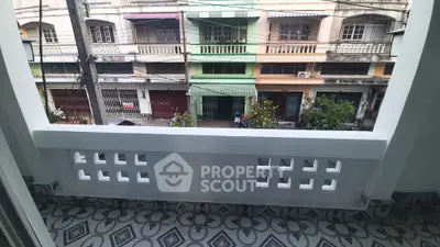 Charming balcony with patterned tiles overlooking vibrant street view