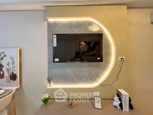 Modern living room with stylish TV setup and decorative lighting