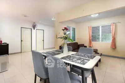 Spacious living and dining area with modern decor and natural light.