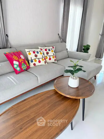 Stylish living room with modern sofa and wooden coffee tables, perfect for cozy gatherings.