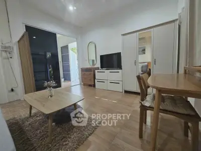 Charming living room with modern furniture and natural light, perfect for relaxation and entertainment.