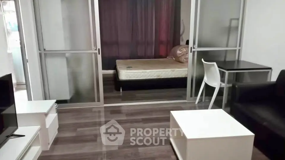 Modern studio apartment with sleek furniture and cozy bedroom area