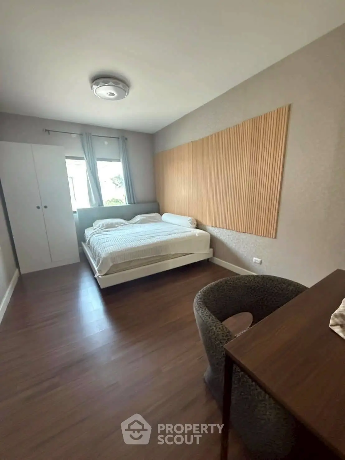 Cozy bedroom with modern decor and ample natural light, featuring a comfortable bed and stylish furnishings.