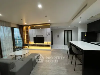 Modern open-layout living room with sleek kitchen and city view