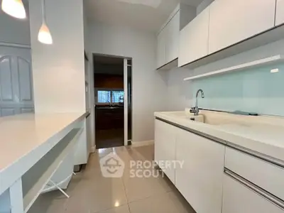 Modern kitchen with sleek white cabinetry and open layout design