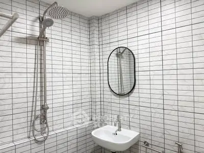 Modern bathroom with sleek white tiles and stylish fixtures
