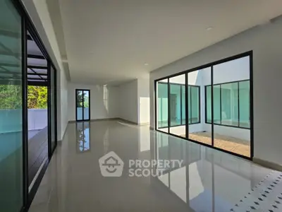 Spacious modern interior with large windows and sleek design, perfect for natural light lovers.